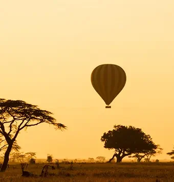 Hot-Air-Balloons-Over-Serengeti-at-Sunrise.-African-Overland
